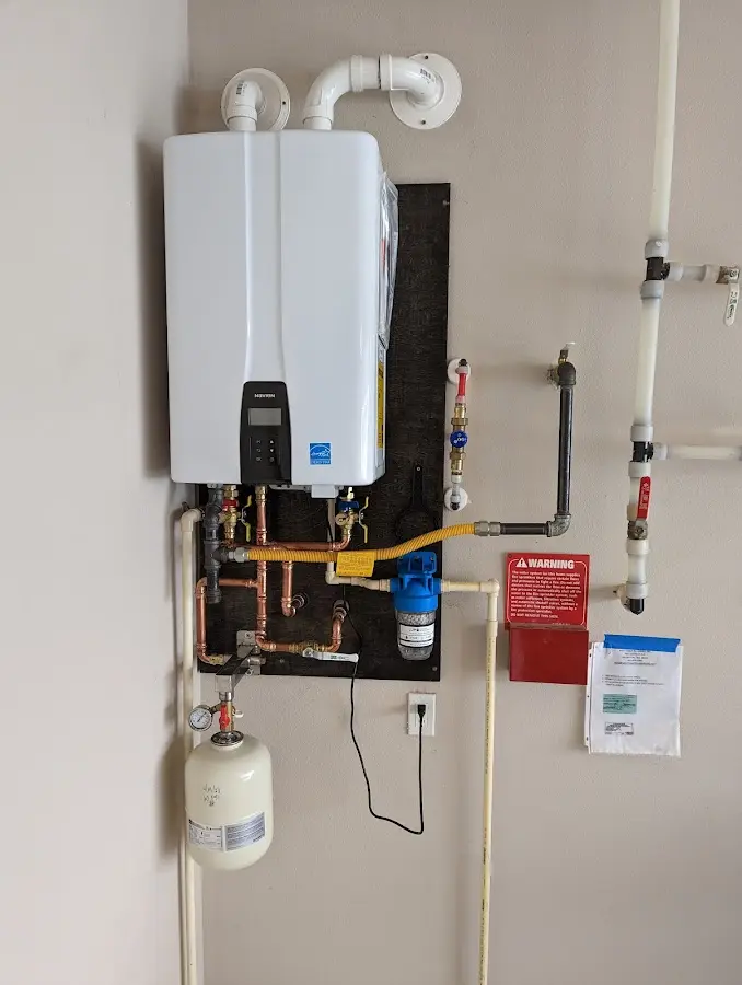 Professional plumber installing copper piping in a South Plainfield home